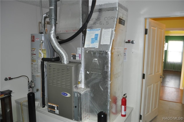 utility room featuring water heater