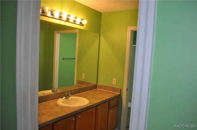 bathroom with vanity and a textured ceiling