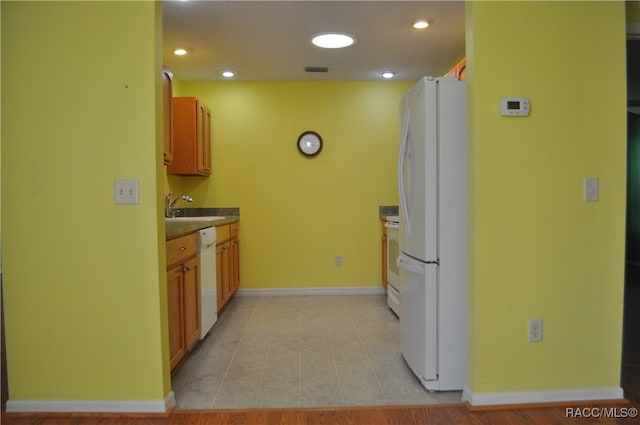 kitchen featuring white appliances and sink