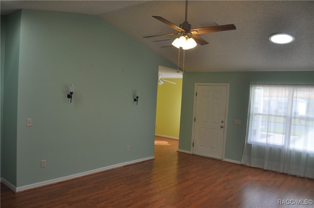 interior space featuring a textured ceiling, ceiling fan, dark hardwood / wood-style flooring, and vaulted ceiling