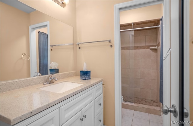 bathroom featuring tile patterned floors, vanity, and walk in shower