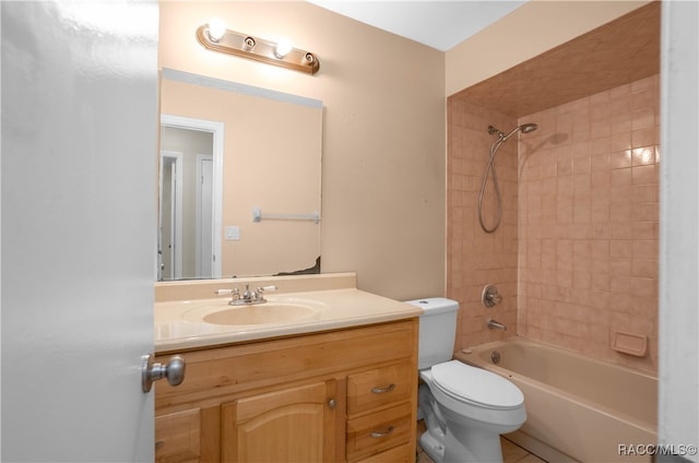 full bathroom featuring vanity, toilet, and tiled shower / bath