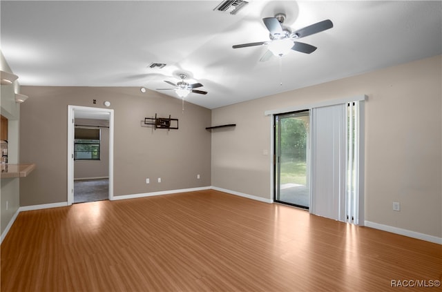 unfurnished living room with ceiling fan, vaulted ceiling, and light wood-type flooring