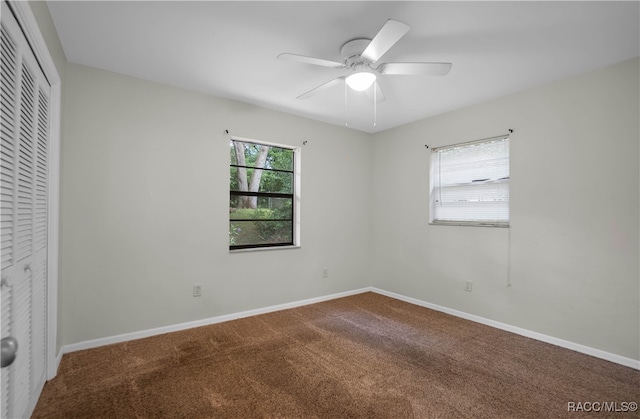 unfurnished bedroom with carpet flooring, a closet, and ceiling fan