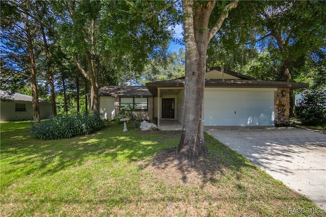 ranch-style house featuring a front yard and a garage