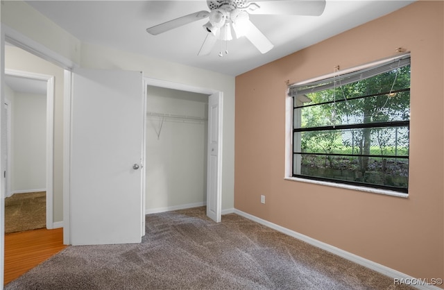 unfurnished bedroom with ceiling fan, carpet floors, and a closet