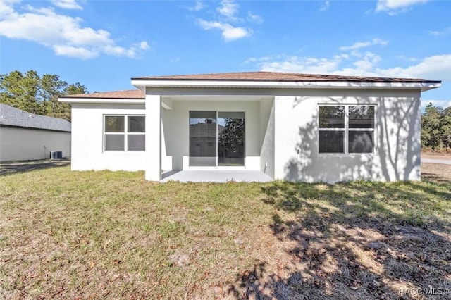 rear view of house featuring a yard and a patio area