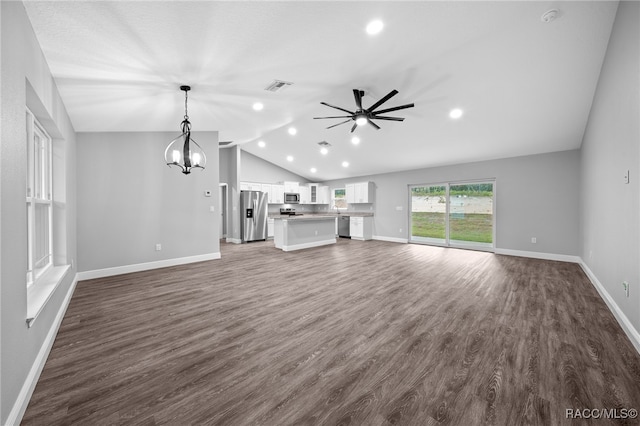 unfurnished living room featuring ceiling fan with notable chandelier, dark hardwood / wood-style flooring, and lofted ceiling