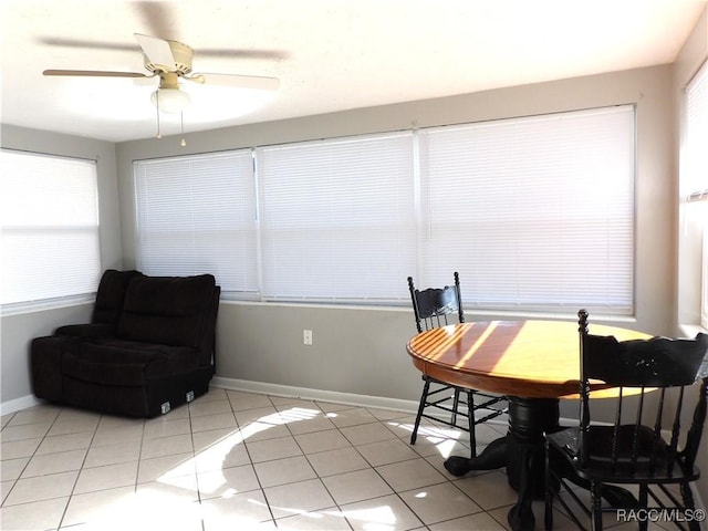 sunroom / solarium featuring plenty of natural light and ceiling fan