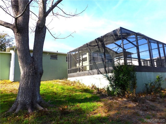 view of side of home with glass enclosure