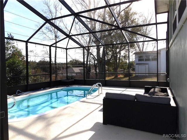 view of swimming pool with a storage unit, a lanai, an outdoor living space, and a patio