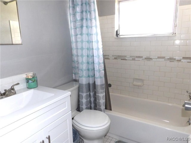 full bathroom featuring vanity, shower / tub combo, and toilet