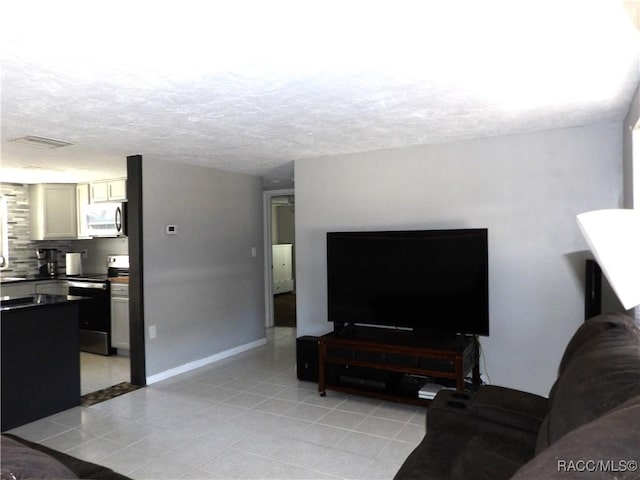 tiled living room with a textured ceiling