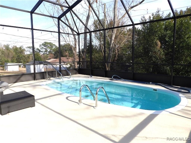 view of pool featuring a patio and glass enclosure