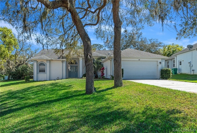 ranch-style house featuring a front yard and a garage