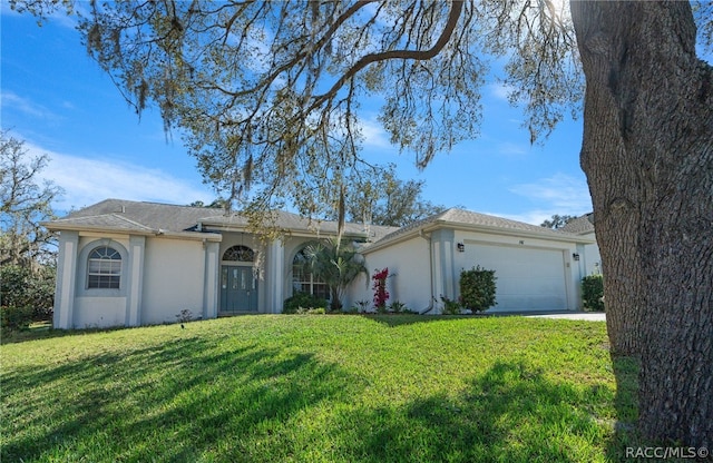 ranch-style home with a garage and a front lawn