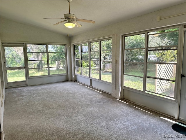 unfurnished sunroom with ceiling fan, a healthy amount of sunlight, and lofted ceiling