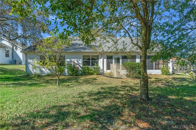 single story home featuring a front yard and central AC