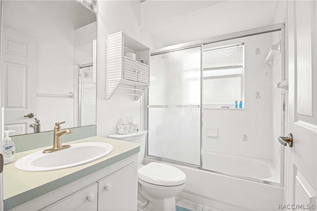 full bathroom featuring shower / bath combination with glass door, vanity, and toilet