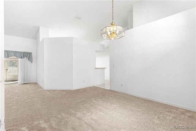 carpeted spare room with a textured ceiling, ceiling fan, and lofted ceiling