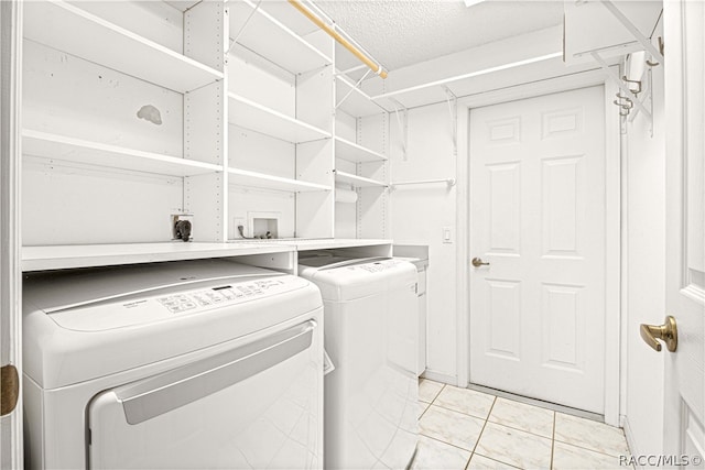 washroom featuring light tile patterned floors and separate washer and dryer