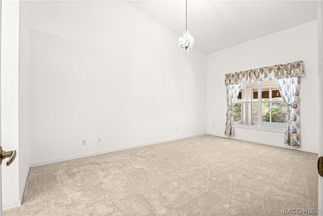 empty room with carpet flooring, vaulted ceiling, and an inviting chandelier