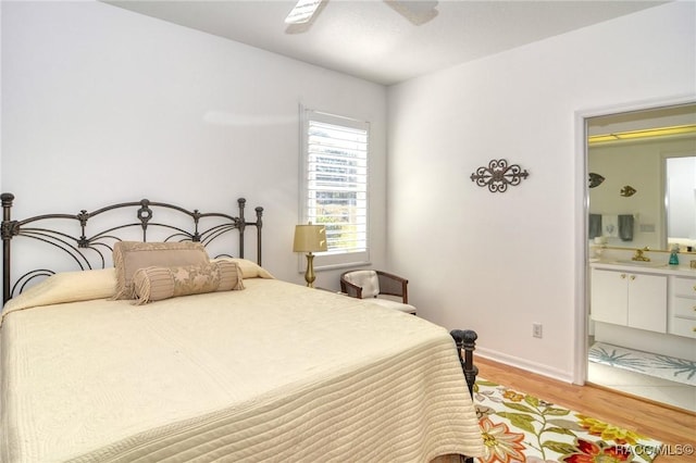 bedroom with light wood-type flooring, ensuite bath, and ceiling fan