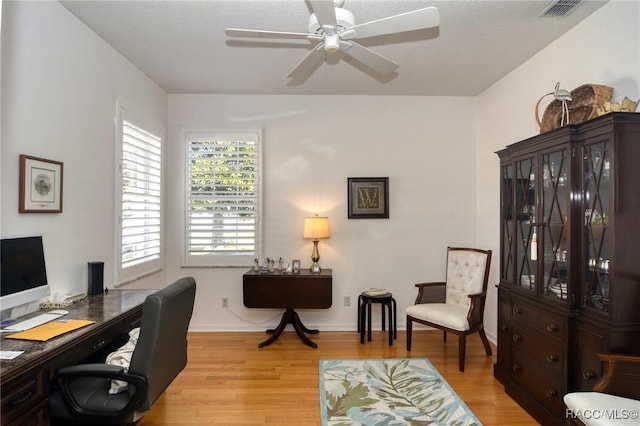 office with ceiling fan and light hardwood / wood-style flooring