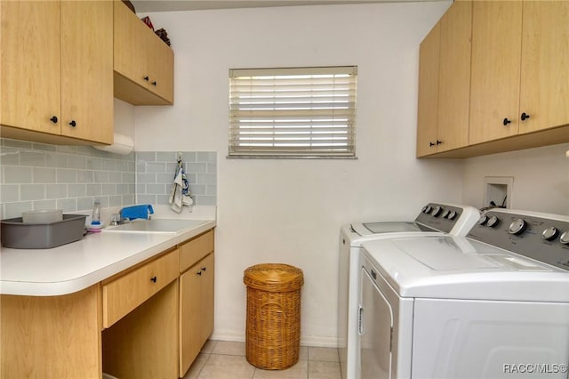 laundry area featuring cabinets, independent washer and dryer, and light tile patterned floors