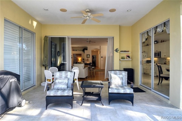 view of patio / terrace featuring area for grilling, ceiling fan, and sink