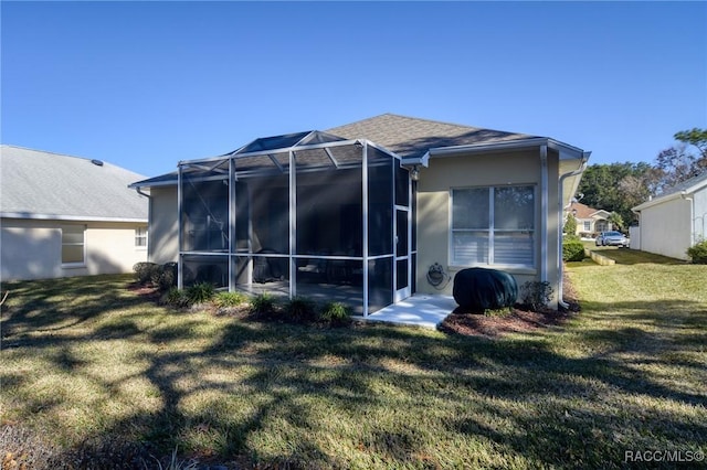 back of house with a lawn and a lanai