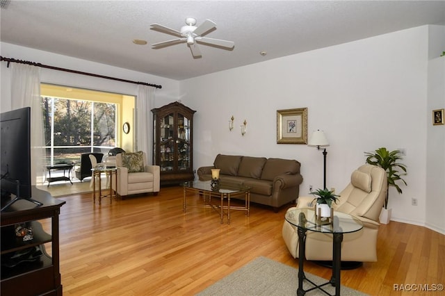 living room featuring ceiling fan and wood-type flooring