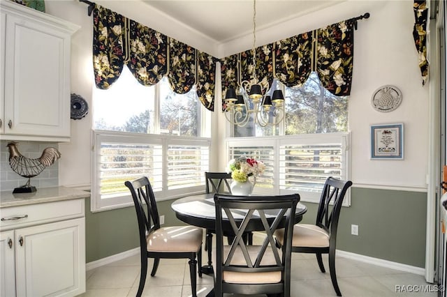 tiled dining area with a chandelier and a wealth of natural light