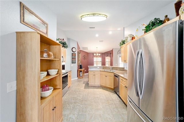 kitchen featuring a peninsula, stainless steel appliances, open shelves, and a sink