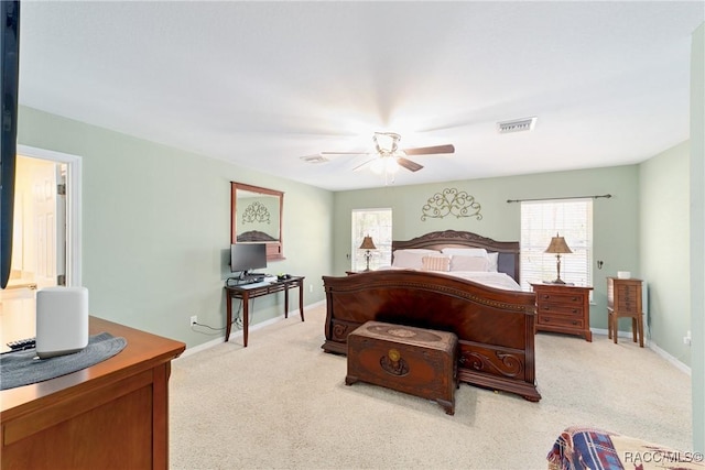 bedroom with light carpet, visible vents, and multiple windows