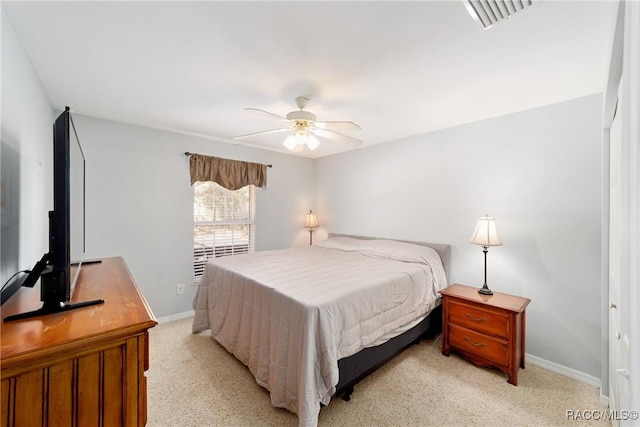 bedroom featuring light colored carpet, baseboards, a ceiling fan, and visible vents