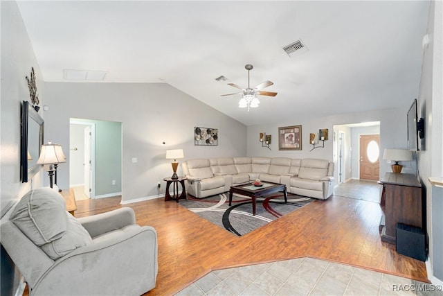 living room with lofted ceiling, visible vents, ceiling fan, baseboards, and light wood-style floors