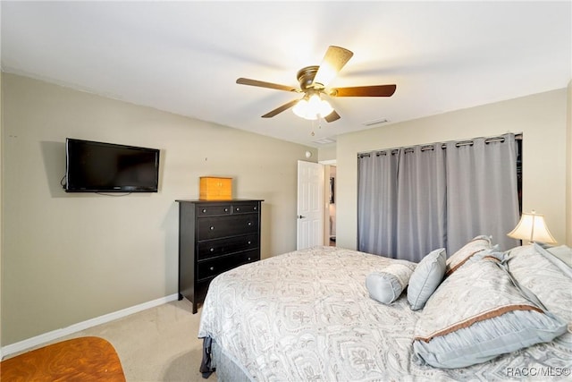 bedroom featuring light colored carpet, baseboards, ceiling fan, and visible vents