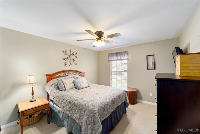 bedroom featuring light carpet, baseboards, and a ceiling fan