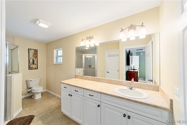 full bathroom featuring toilet, a stall shower, tile patterned floors, baseboards, and vanity