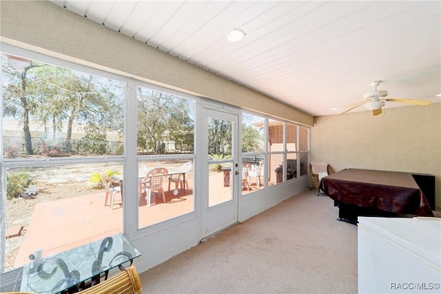 sunroom / solarium featuring a ceiling fan