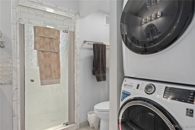 laundry area featuring stacked washer / dryer