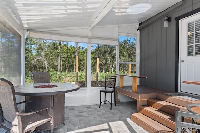 sunroom with lofted ceiling with beams