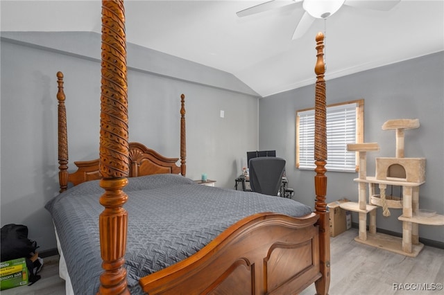 bedroom with light hardwood / wood-style flooring, vaulted ceiling, and ceiling fan