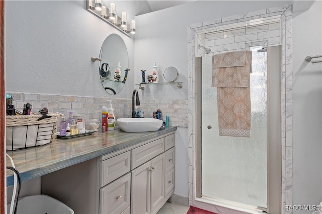 bathroom with tile patterned flooring, vanity, walk in shower, and tasteful backsplash