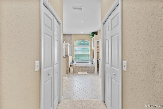 hallway with light tile patterned floors