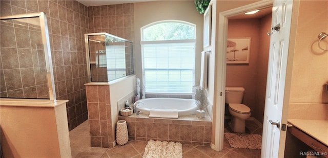 bathroom featuring separate shower and tub, tile patterned floors, and toilet