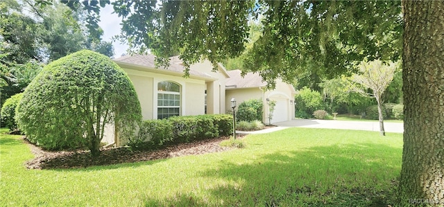 view of front of property with a front yard and a garage