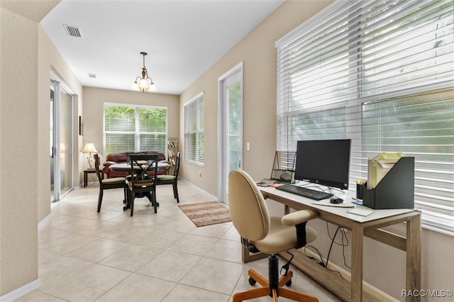 office space featuring light tile patterned floors and an inviting chandelier