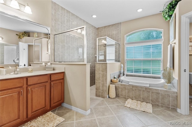 bathroom with tile patterned floors, vanity, and plus walk in shower